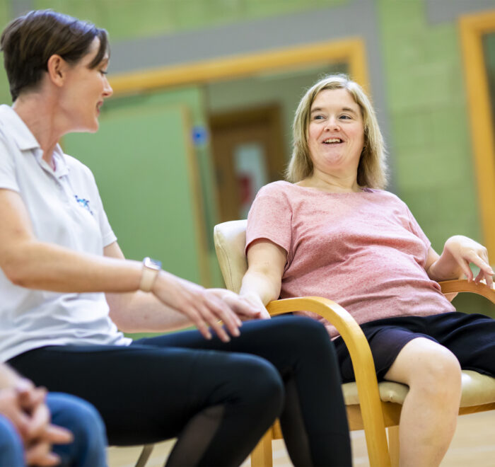 Living-3 Two women sitting on chairs in a circle in a leisure centre setting