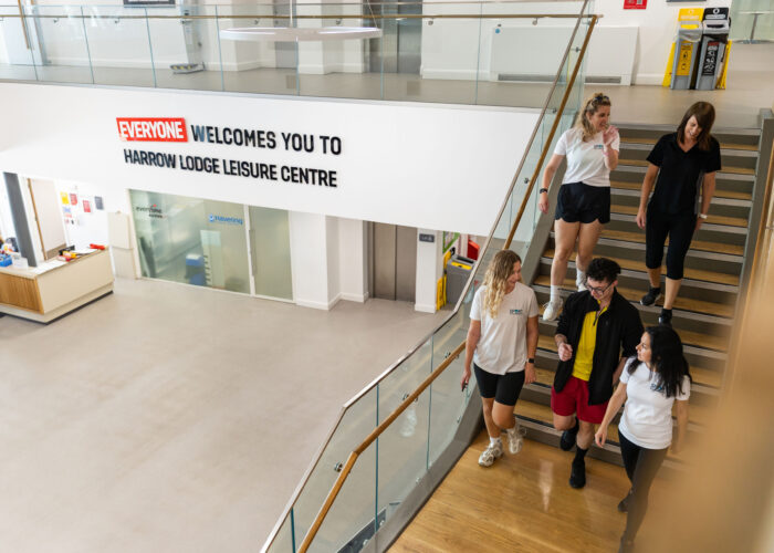 A group of people walking down stairs in a leisure centre entrance