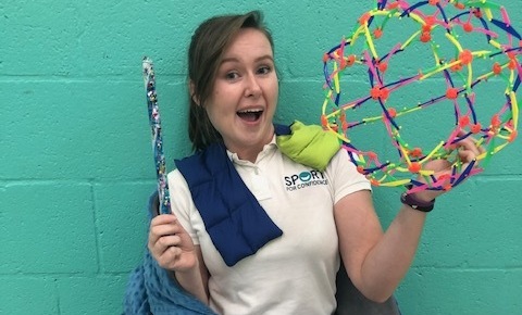 Sport for Confidence coach holding sensory activity equipment