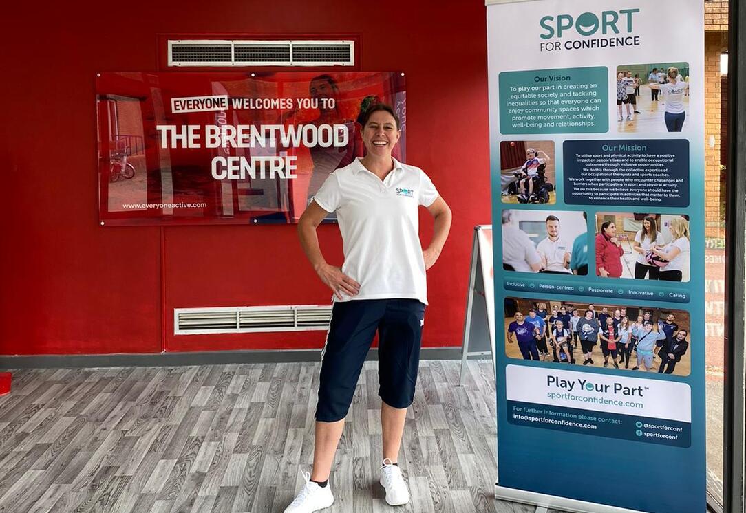 Sport for Confidence staff member standing beside promotional display at Brentwood Centre