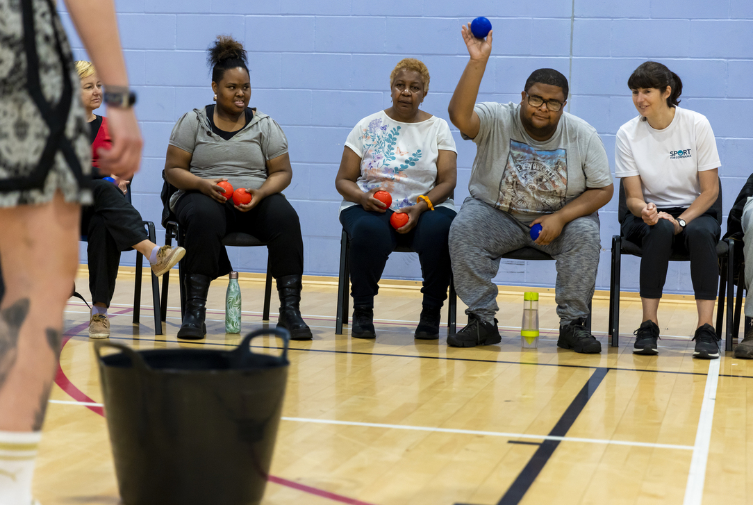 Participants taking part in an inclusive seated ball game activity