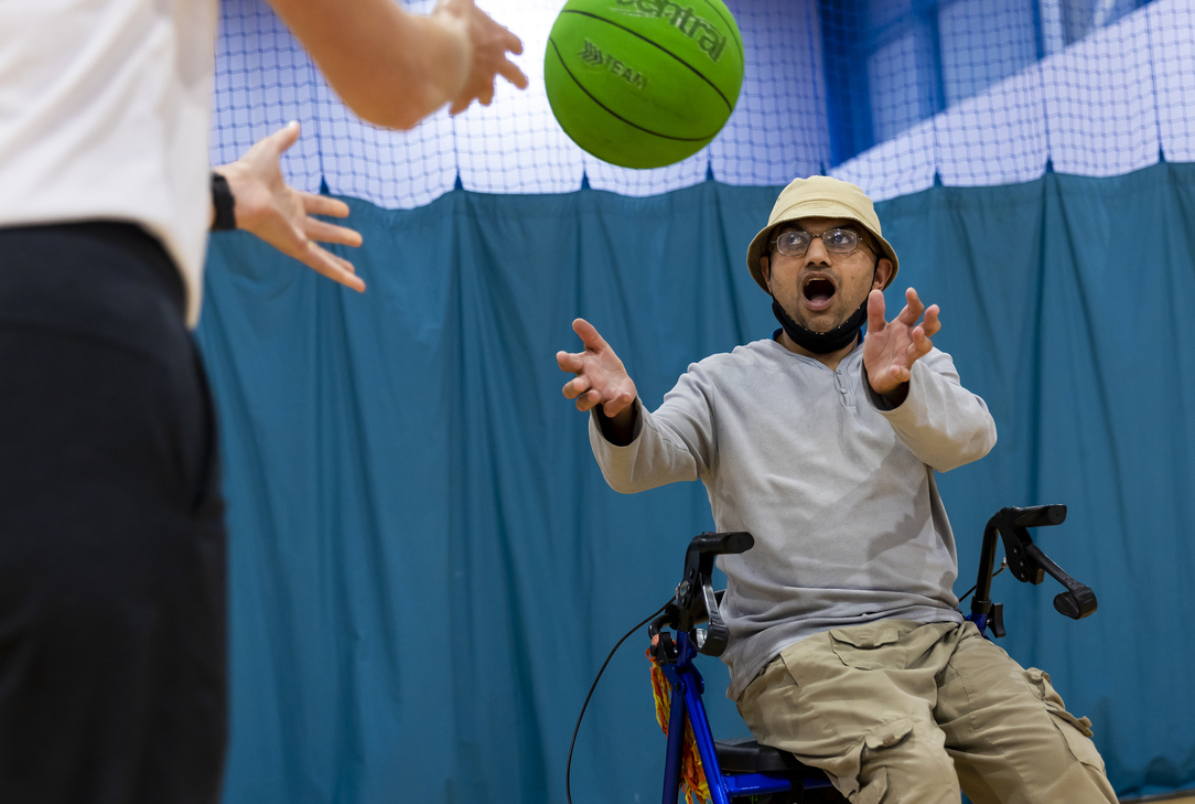Participant catching a ball during an inclusive indoor sports activity