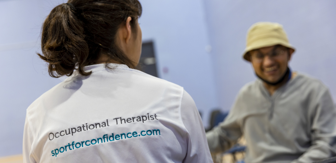 Occupational therapist from Sport for Confidence speaking with a participant during a session