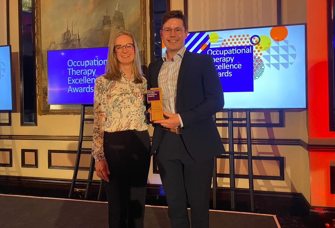 Two attendees posing with an award at the Occupational Therapy Excellence Awards