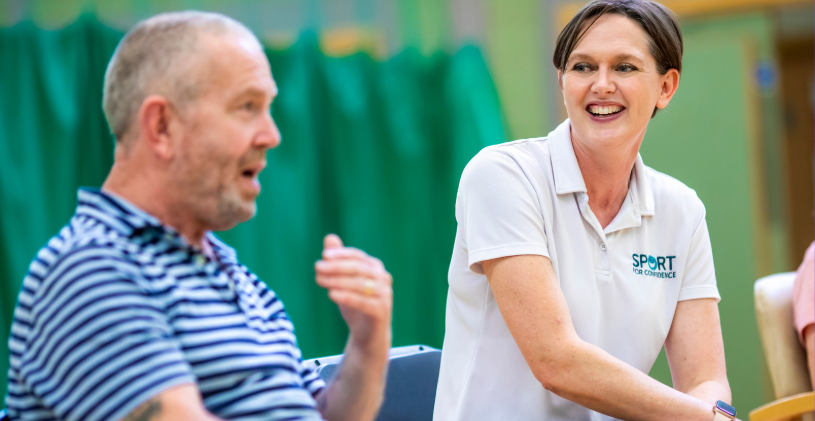 Lyndsey Barrett, Co-CEO, talking with a participant during an indoor activity session