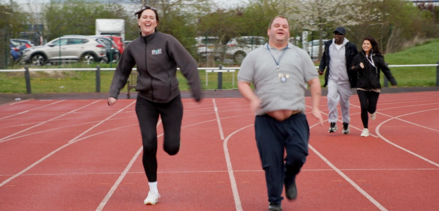 Inclusive sports session with participants jogging on a running track